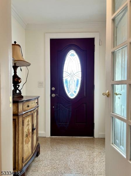 entryway featuring ornamental molding