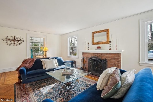 living room with parquet floors, plenty of natural light, and a brick fireplace