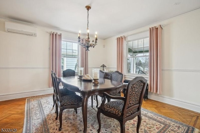 dining room with parquet flooring, an AC wall unit, and an inviting chandelier