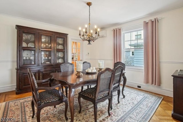 dining space featuring light parquet flooring, a wall unit AC, a notable chandelier, and crown molding