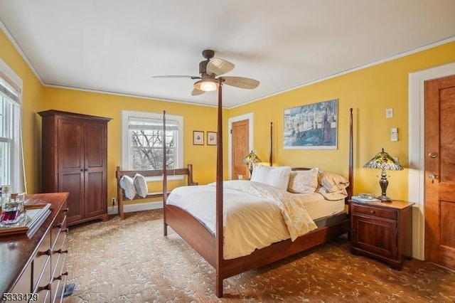 bedroom with ornamental molding and ceiling fan