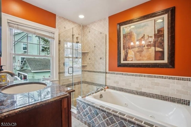 bathroom featuring vanity and shower with separate bathtub