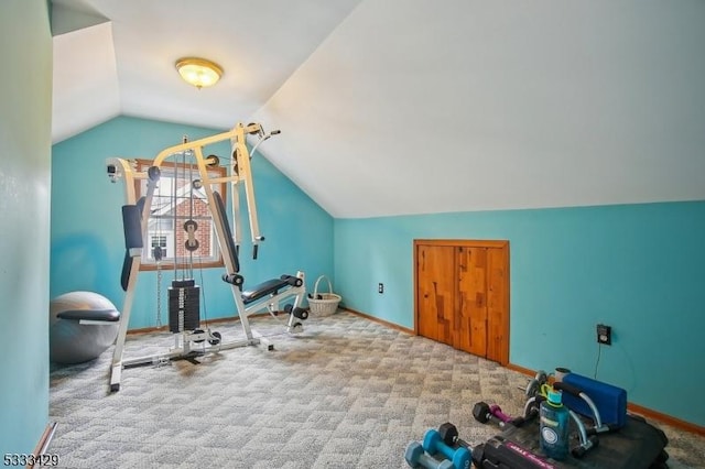 exercise room with lofted ceiling and light carpet