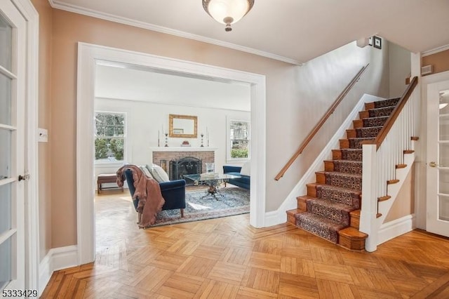 interior space with parquet floors, crown molding, and a fireplace