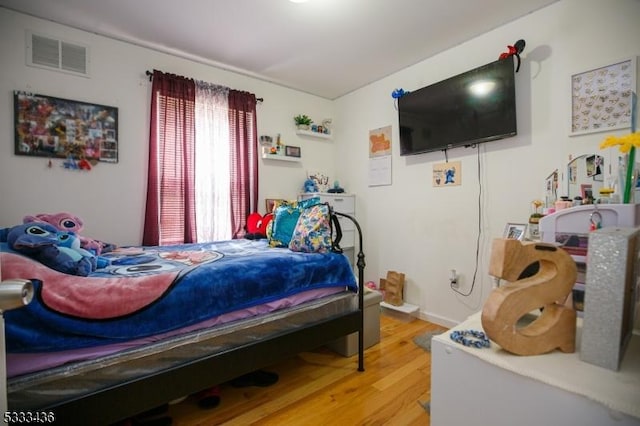 bedroom with hardwood / wood-style floors