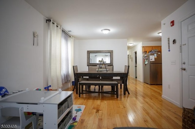 dining area with light hardwood / wood-style floors