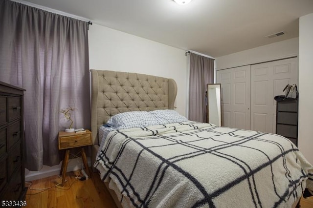 bedroom with a closet and hardwood / wood-style flooring