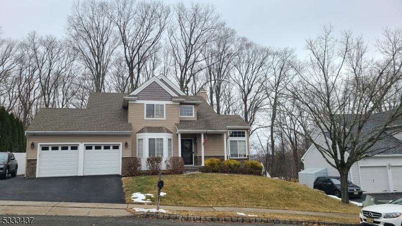 view of property with a garage and a front lawn