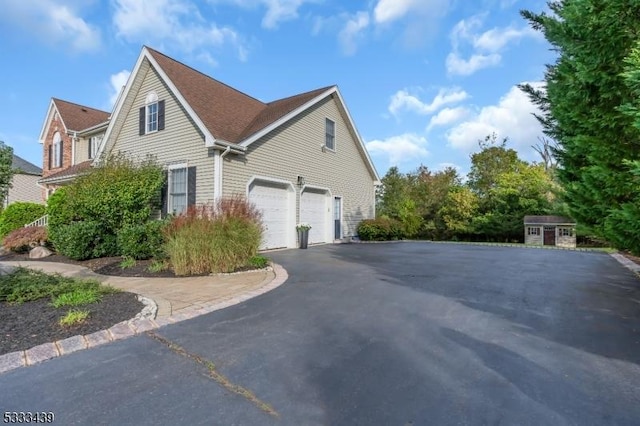 view of property exterior with a shed and a garage