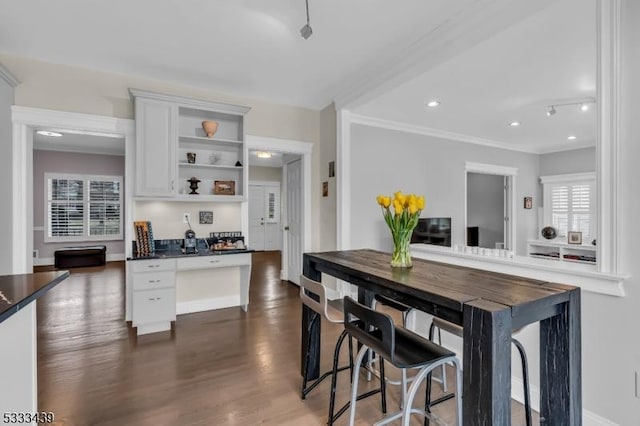 kitchen featuring white cabinets, dark hardwood / wood-style floors, and crown molding