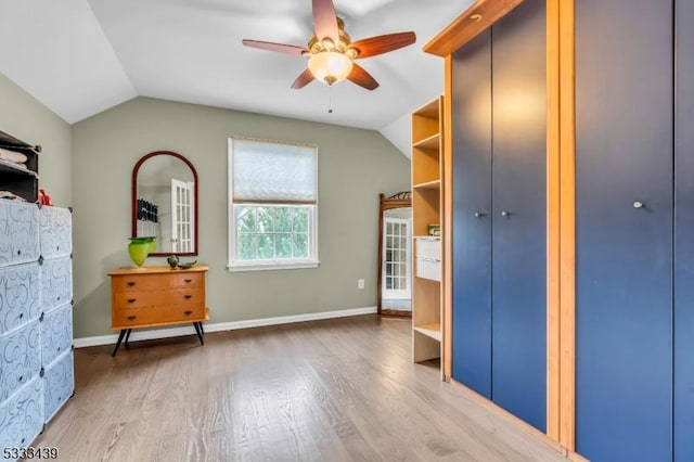 unfurnished bedroom featuring vaulted ceiling, ceiling fan, a closet, and hardwood / wood-style flooring