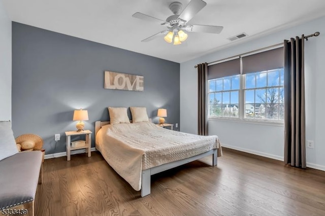 bedroom with ceiling fan and dark hardwood / wood-style flooring