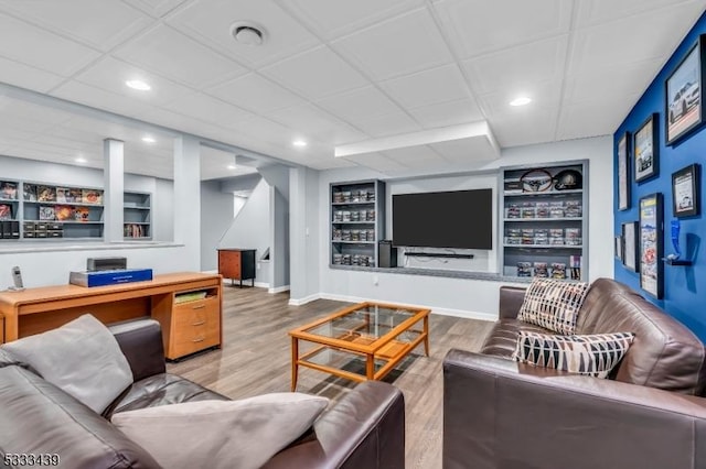 living room featuring hardwood / wood-style floors and built in features