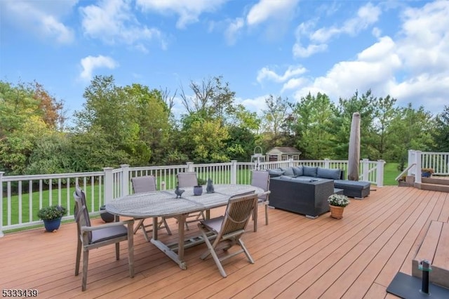 deck with an outdoor hangout area and a shed