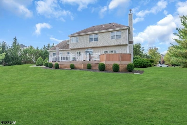 rear view of property with a lawn