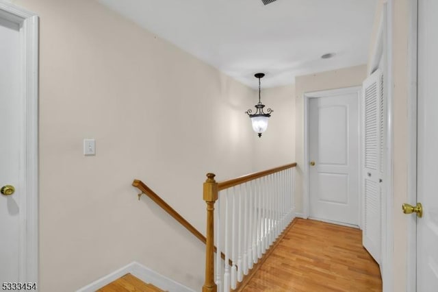 stairway with hardwood / wood-style floors