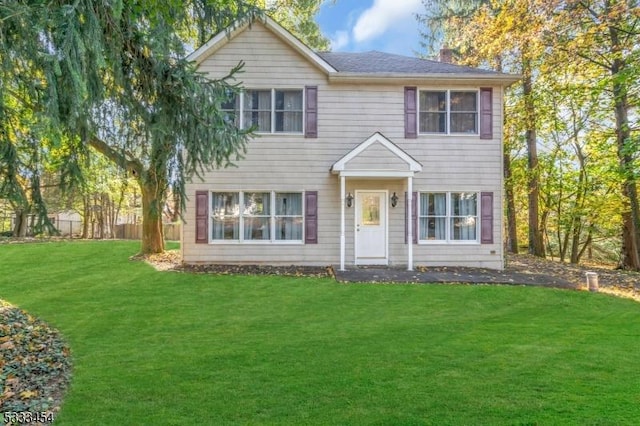 colonial inspired home with a front lawn