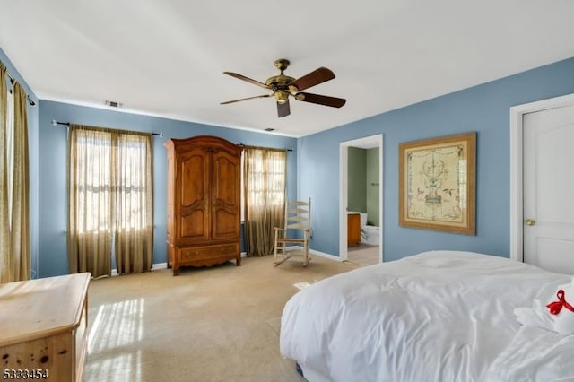 carpeted bedroom with ceiling fan and connected bathroom