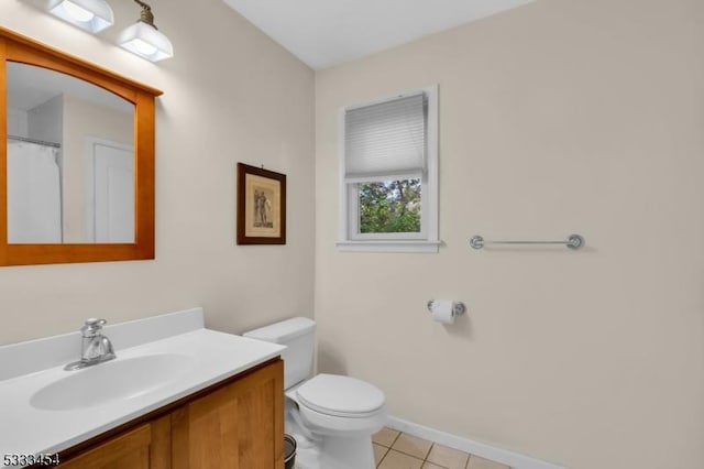 bathroom with toilet, tile patterned flooring, and vanity