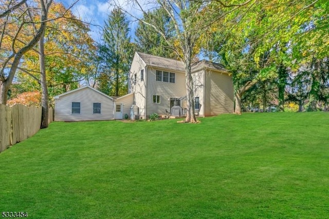 back of house with a lawn