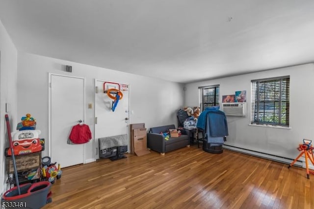 playroom featuring a baseboard radiator, hardwood / wood-style floors, and cooling unit