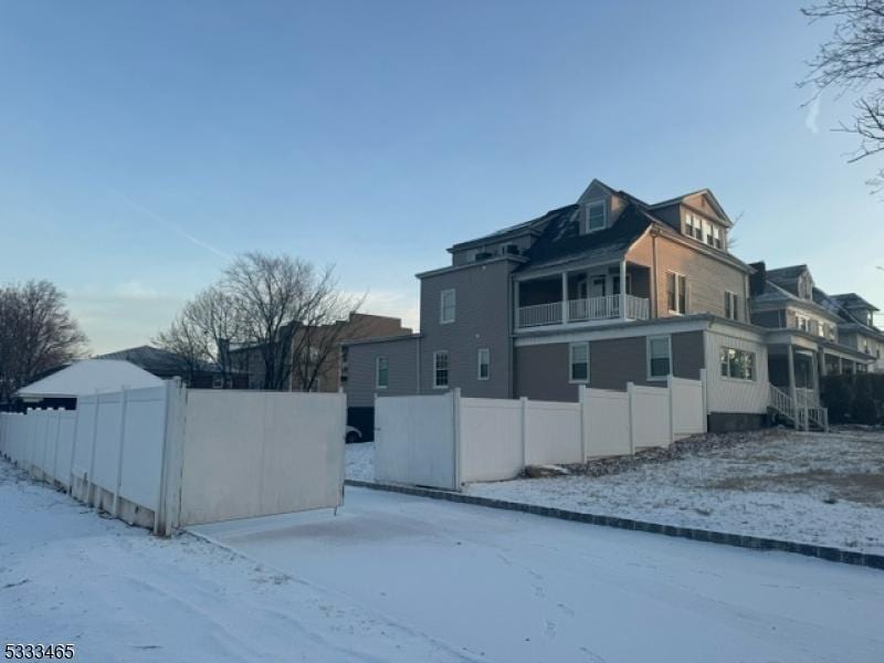 snow covered property with a balcony