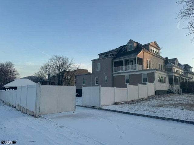 snow covered property with a balcony