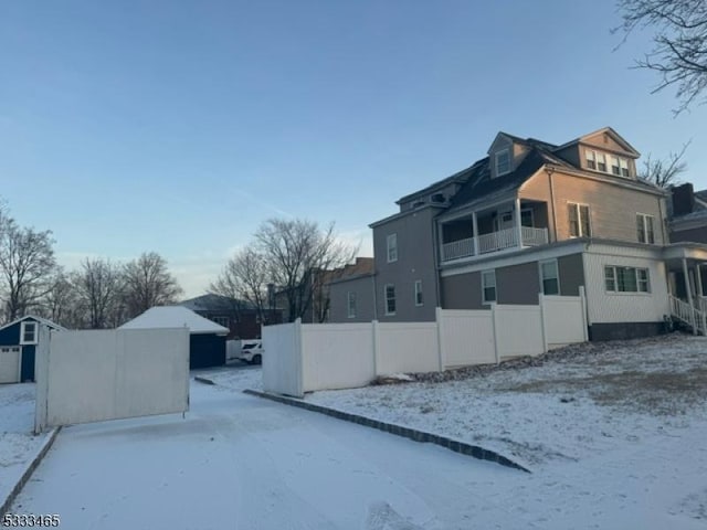 view of snowy exterior featuring a balcony