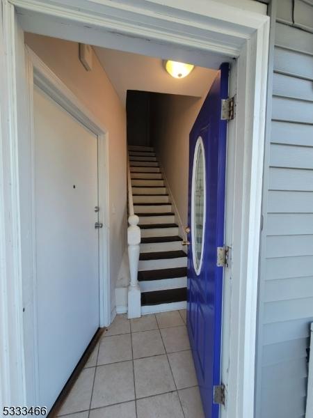 staircase featuring tile patterned flooring