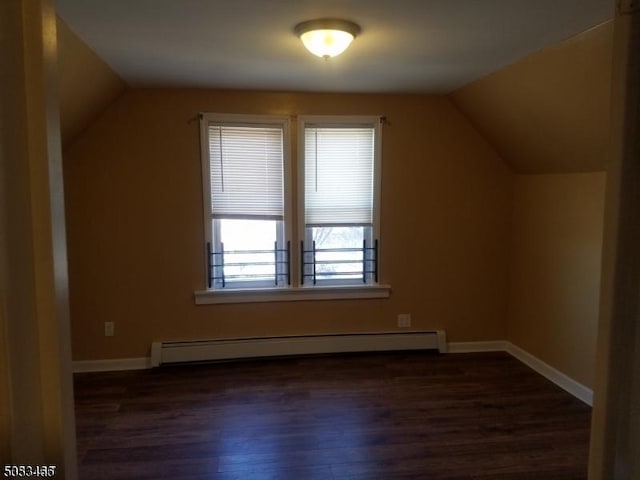 bonus room with baseboard heating, dark hardwood / wood-style flooring, and vaulted ceiling