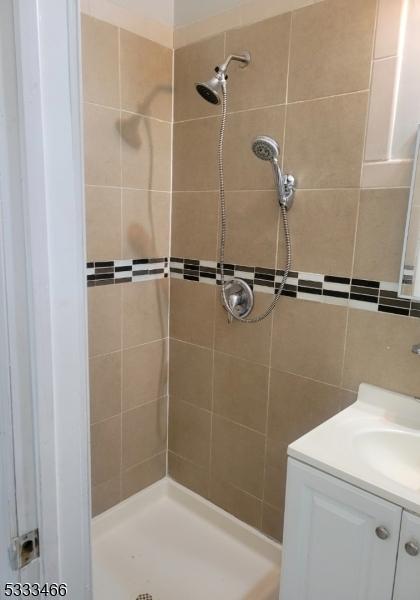 bathroom featuring vanity and a tile shower