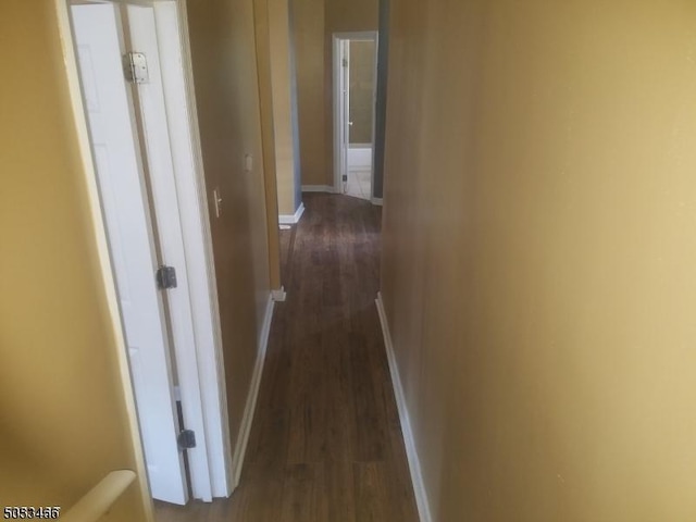 corridor with dark hardwood / wood-style floors