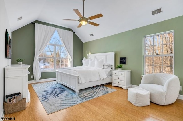 bedroom featuring vaulted ceiling, light wood-type flooring, and ceiling fan