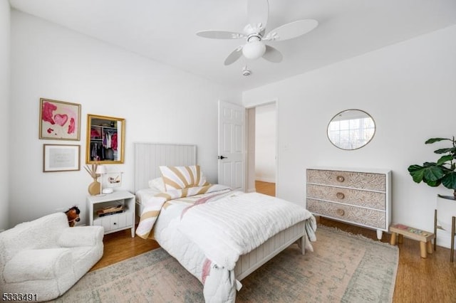 bedroom with ceiling fan and hardwood / wood-style floors