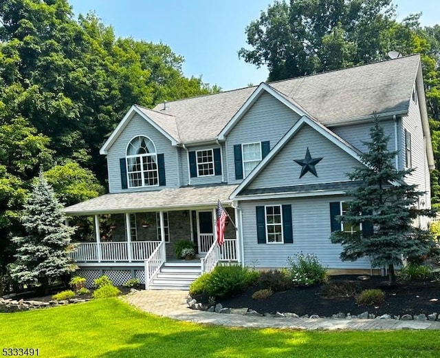 view of front facade with a front yard and covered porch