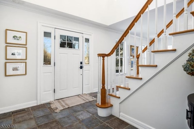 entrance foyer featuring ornamental molding