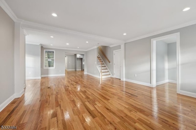 unfurnished living room with ornamental molding and light hardwood / wood-style flooring