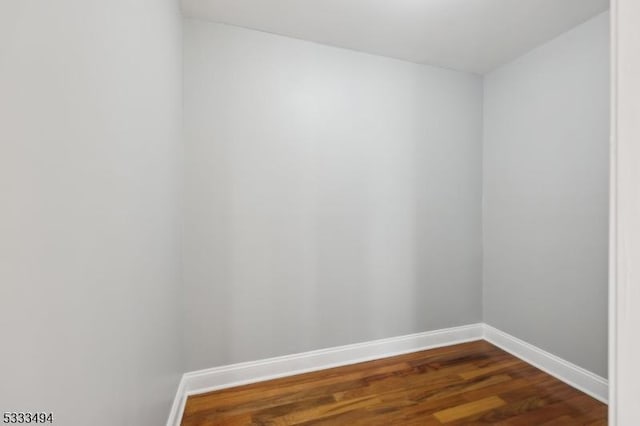 spare room featuring dark hardwood / wood-style flooring