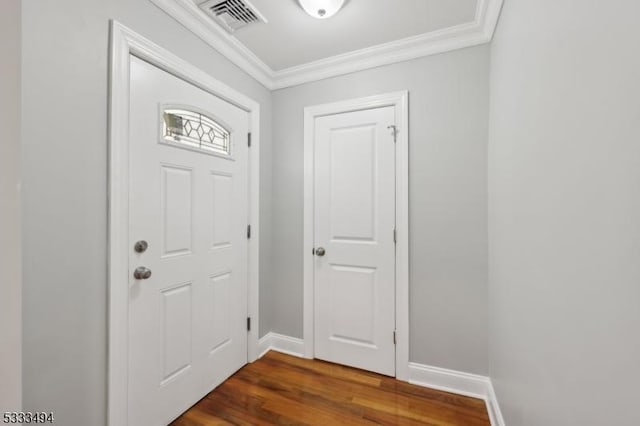 entryway with dark hardwood / wood-style flooring and ornamental molding