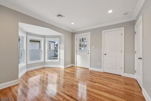 interior space with hardwood / wood-style floors and crown molding