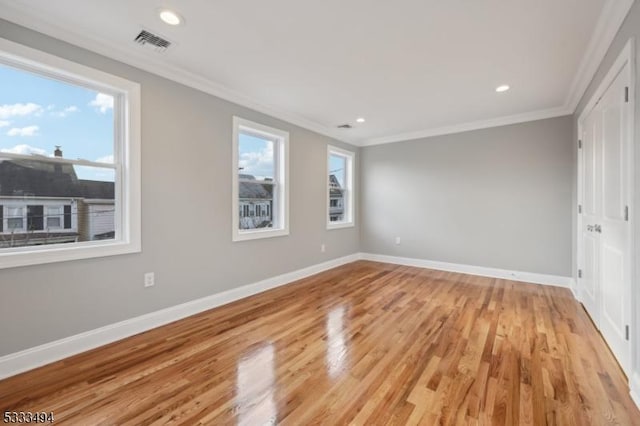 unfurnished bedroom featuring light wood-type flooring and ornamental molding