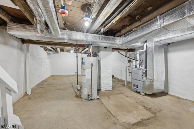 basement featuring heating unit and water heater