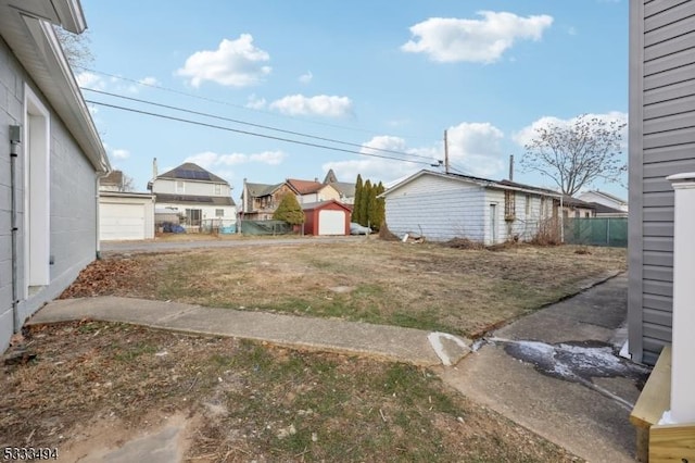 view of yard featuring an outbuilding and a garage