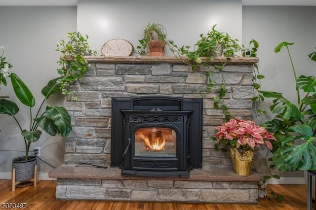 interior details featuring hardwood / wood-style flooring and a wood stove