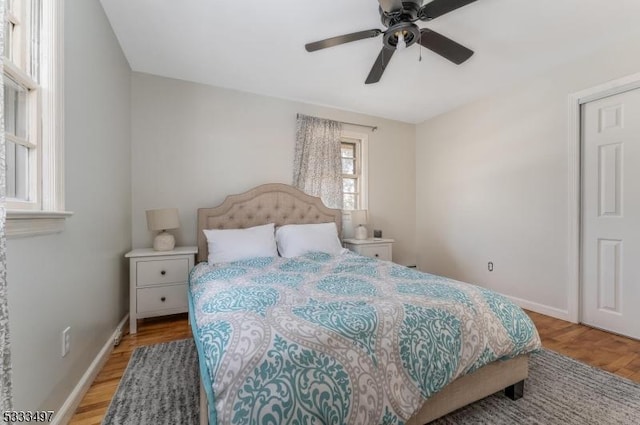 bedroom with light hardwood / wood-style floors and ceiling fan