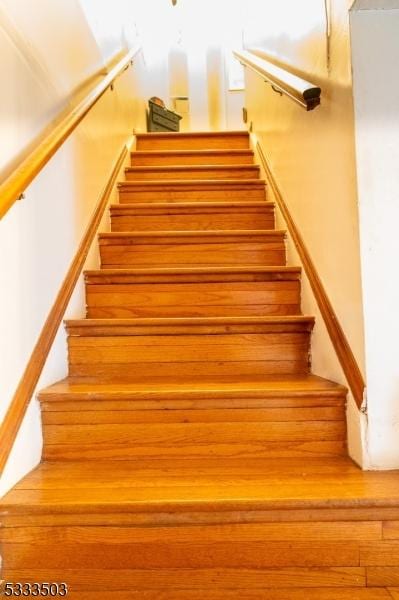 stairway featuring wood-type flooring