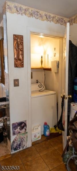 laundry room featuring tile patterned floors and washer / clothes dryer