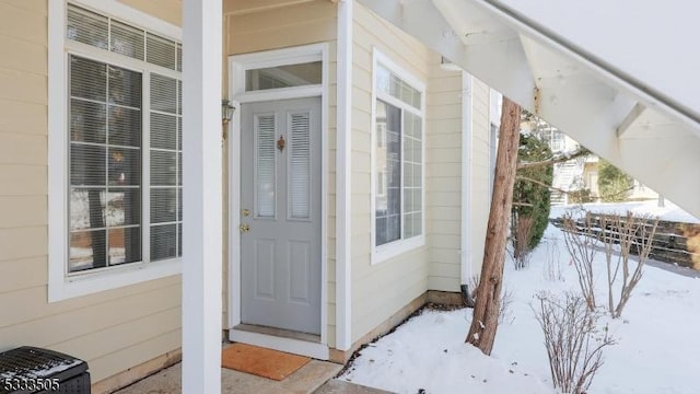 view of snow covered property entrance