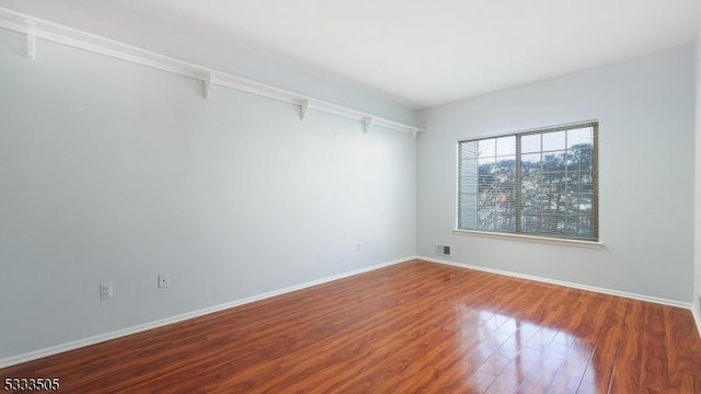 unfurnished room featuring hardwood / wood-style floors