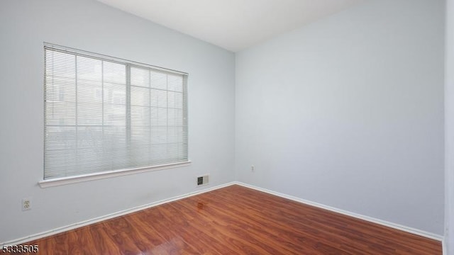 unfurnished room featuring hardwood / wood-style floors